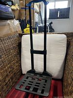 Front view of the dolly with handle extended showing the platform and frame.