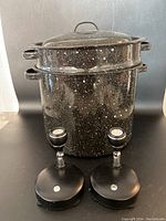 Full lot including the black speckled granite ware canning pot with steaming insert and two LED battery operated color-changing lights shown against a gray background.