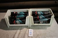 16 black tubes of Petro Canada MultiFlex Moly Special grease in white crates, showing quantity and packaging.