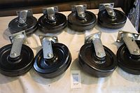Set of 8 castors showing 4 fixed and 4 swivel castors with composite plastic wheels on metal brackets.