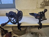 Side view showing apple peeler and cherry pitter mounted on a table, visible hand crank and clamp