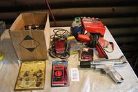 Overall view showing the box of parts and timing lights on table with other electrical tools and a red MSD spark control module.