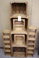 Stacked set of crude wooden boxes showing various sizes and slatted construction.