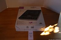 Salton induction cooktop box, front showing the product image, brand name, and product details.