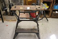 Front view of Black & Decker WorkMate 300 showing wooden top with wear and metal frame.