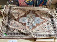 Full view of handwoven area rug showing its design and color pattern.