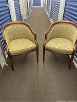 Pair of Barrymore bucket chairs with fabric upholstery and wooden frames shown from front