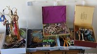 Overall view showing necklace stand, decorative boxes and plastic organizers containing jewelry