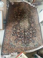 Entire rug laid flat on carpet showing full design and overall condition