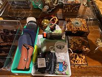 Overhead view of sunglasses, cases and tortoiseshell boxes