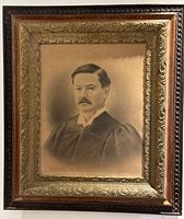 Front view of entire framed portrait showing wood and gold ornate frame edges with vintage man portrait inside.