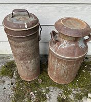 Both milk cans side by side with lids in place, showing overall shapes and relative sizes