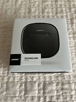 Front view of the unopened Bose SoundLink Micro Bluetooth speaker box showing product image and branding.