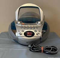 Front and side view of Memorex cassette and CD player with attached power cord, showing overall design and condition