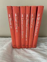 Spines of six hardcover children's classic books in red with white text, titles visible: Bambi, Lad: A Dog, Lassie Come-Home, Misty of Chincoteague, Rascal, The Black Stallion.