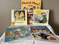 Five Robert Munsch books displayed on a surface showing all titles and colorful covers.