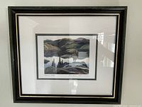 Front view of framed print showing landscape with hills and lake