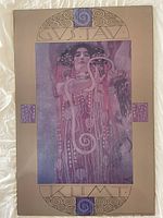 Full view of the mounted painting fragment showing the central figure and decorative border with 'Gustav Klimt' text.