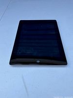 Front view of Apple iPad showing black screen and front camera