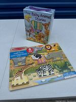 Melissa & Doug wooden 8-piece animal chunky puzzle and Disney Baby Animal Stories boxed set with 12 board books.