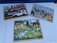 Three Melissa & Doug wooden puzzles are shown. One has emergency vehicles (fire truck, police car, ambulance). Another has horses in nature. The third shows people skating outdoors in winter.