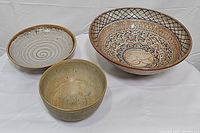 Three ceramic bowls shown together with clear visibility of patterns and finishes