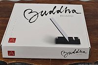 Original white Buddha Board box with branding and image of the brush and stand on top.