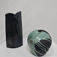 Front view of two vases side by side showing shape and color contrast