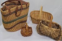 All four baskets together on a white surface showing varying sizes and weave patterns