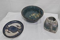 Full set of three ceramics displayed, showing variety of shapes and designs
