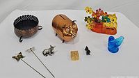 Full lot including copper candle holder, copper piggy bank with eyes and snout, two tiny metal animal statues, butterfly bookmarks, blue bird paperweight, and orange/yellow acrylic owl and flower piece