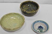 Three round ceramic bowls arranged together, showing size and color differences.