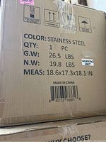 Photo of cardboard box showing weight, size, and color indicating stainless steel oven inside, gross weight 26.5 lbs, net weight 19.8 lbs.