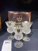 Three Edinburgh Crystal glasses - 1 claret and 2 white wine glasses - in front of branded box.