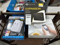 All three sealed boxed items displayed side by side