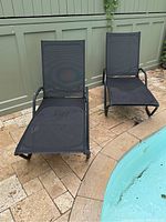 Both chairs side by side next to pool, showing overall appearance