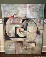 Full view of large rectangular abstract geometric canvas painting leaning against wall