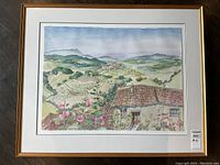 Frontal view of matted and framed watercolor landscape