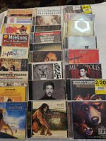 Photo showing full collection of 24 music CDs in jewel cases, various artists and soundtracks visible