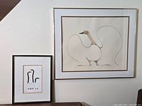 Two framed Benjamin Chee Chee artworks on wall, smaller 'Friends' on left, larger 'Dancing Goose' on right, showing relative size and display condition.