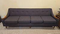 Full view of four-seat sofa showing overall style and condition