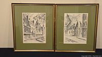 Two framed black and white sketches of Quebec street scenes, showing the overall lot contents.