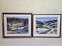 Two framed oil paintings side by side, depicting Laurentian landscapes