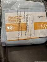 Photo of packaged full length hanging coat organizer with label showing product name, dimensions, and usage.