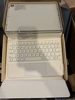 Wireless keyboard and case for iPad, inside the box; white keyboard with trackpad and protective case insert