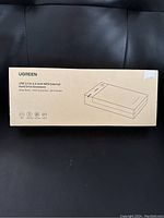Closed box with Ugreen branding and product description showing USB 3.0 2.5/3.5 inch SATA external hard drive enclosure.