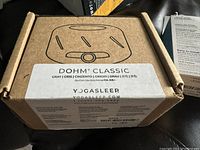 Brown cardboard box with YogaSleep and DOHM Classic branding, gray color noted on label.