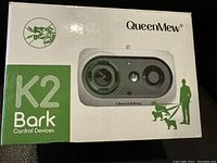 Closed box of QueenMew K2 Bark Control Device showing branding and product image on front.