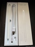 Image of the stylus pen kit in original box, showing pen, USB charging cable, and extra tip.