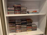 Shelves with a large collection of music CDs stacked and organized
